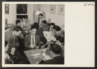 [recto] At the relocation hostel in Philadelphia, Pennsylvania, the local Nisei Steering Committee is holding its weekly social for players of ...