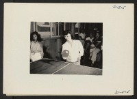 [recto] Manzanar, Calif.--Chiyeko Nakashima, high school student, plays table tennis in girls' recreation hall at Manzanar, a War Relocation Authority center where persons of Japanese ancestry will spend the duration. ;  Photographer: Stewart, Francis ;  Manz