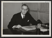 [recto] Paul C. Dougherty is the Relocation Officer in charge of the Chicago district office, which includes the metropolitan area of Chicago and the northern counties of Indiana. ;  Photographer: Mace, Charles E. ;  Chicago, Illinois.
