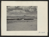 [recto] Looking west over the Heart Mountain Relocation Center with its sentry name sake Heart Mountain on the horizon. ;  Photographer: Parker, Tom ;  Heart Mountain, Wyoming.