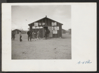 [recto] One of the barracks at this center which is used for a high school. As yet the students haven't decided on a name for the school. ;  Photographer: Stewart, Francis ;  Newell, California.