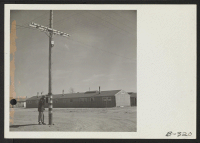 [recto] An evacuee fireman checks with his Chief from a fire alarm box which is located on a telephone pole. These alarm boxes are conveniently located throughout the center. ;  Photographer: Stewart, Francis ;  Topaz, Utah.