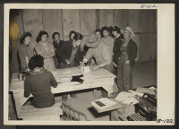 [recto] Manzanar, Calif.--Registering for work at this War Relocation Authority center, under the Work Corps plan for evacuees. ;  Photographer: Albers, Clem ;  Manzanar, California.