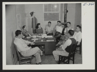 [recto] Paul A. Taylor, Project Director, holding a conference with the Council Committee in his office. ;  Photographer: Parker, Tom ;  Denson, Arkansas.