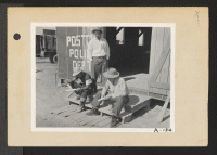 [recto] Poston, Ariz.--Members of the police department carving clubs at this War Relocation Authority center for evacuees of Japanese ancestry. (L to R) standing: Chief Kiyoshi Shigekawa; Tochio Ikeda and Hitoshi Nitta. ;  Photographer: Clark, Fred ;  Poston