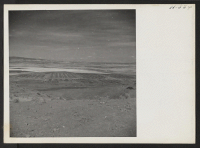 [recto] A distant view of the Tule Lake Relocation Center and a portion of its vast agricultural project. ;  Photographer: Mace, Charles E. ;  Newell, California.