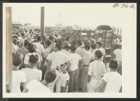 [recto] Showing a part of the crowd assembled to see the Gripsholm voyageurs off and the baggage trucks which carried their effects to Rivers, thence to an eastern seaport where they embarked Sept. 1, 1943. ;  Photographer: Brown, Pauline Bates ;  Poston, Ari