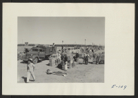 [recto] As carloads of personal belongings arrived at this relocation center, they were taken to the central square and sorted alphabetically and distributed to the barracks. ;  Photographer: Parker, Tom ;  Heart Mountain, Wyoming.