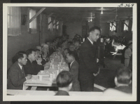 [recto] Resident church workers enjoy themselves at the tea honoring Rev. E. Stanley Jones which was held at the Protestant Church. ;  Topaz, Utah.