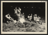 [recto] Closing of the Jerome Center, Denson, Arkansas. Farewell wiener roast held in one of the open spaces between blocks the evening before the participants depart for other centers. ;  Photographer: Iwasaki, Hikaru ;  Denson, Arkansas.