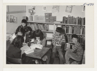 [recto] A corner of the grade school library in one of the barracks. ;  Photographer: Parker, Tom ;  Amache, Colorado.