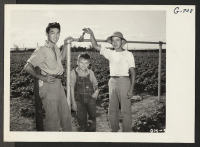 [recto] Jerry Hashii (left), formerly of Santa Anita, and Henry Kodama, formerly of Tule Lake, with one of the boys of ...