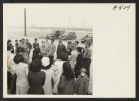 [recto] Master Sergeant Charles Akiyama, acting as the liaison personnel at the Port of Los Angeles, briefs a group of Japanese ...