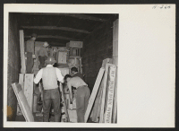 [recto] A view inside a baggage car showing freight being loaded for shipment to other centers. ;  Photographer: Mace, Charles E. ;  Newell, California.
