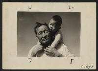 [recto] Manzanar, Calif.--Grandfather and grandson of Japanese ancestry at this War Relocation Authority center. ;  Photographer: Lange, Dorothea ;  Manzanar, California.