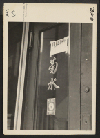 [recto] Entrance to a restaurant vacated by a proprietor of Japanese descent prior to evacuation. Evacuees of Japanese ancestry will be housed in War Relocation Authority centers for the duration. ;  Photographer: Lange, Dorothea ;  San Francisco, California.
