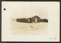[recto] Poston, Ariz. (Site #1)--Barrack building typical of those at this War Relocation Authority center for evacuees of Japanese ancestry. Note the double roof construction for protection against the elements. ;  Photographer: Clark, Fred ;  Poston, Arizon