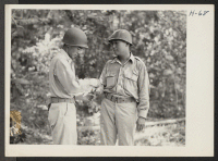 [recto] Captain Nakada, right, in command of the 232nd engineers, confers with Lieutenant Kobata. The 442nd combat team at Camp Shelby ...