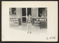 [recto] Sacramento, Calif.--A resident of Japanese ancestry seen in front of the grocery store of which he is a manager, two days before evacuation. He is a graduate of Sacramento Junior College. ;  Photographer: Lange, Dorothea ;  Sacramento, California.
