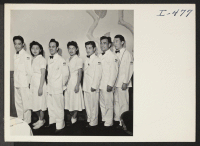[recto] Seven Nisei waiters employed at the Elms Hotel, resort center about thirty miles north of Kansas City, are standing as ...