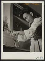 [recto] In the laboratory at the center hospital, Iiuao Oyama, laboratory technician, performs a urinalysis. Oyama, a former Californian of Japanese ancestry, now resident at the Jerome Center. ;  Photographer: Parker, Tom ;  Denson, Arkansas.