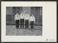 [recto] A group of four supervisors, who direct the activities of the rest of the wardens. Evacuee wardens patrol the relocation center 24 hours a day, and are responsible for the maintenance of law and order. ;  Photographer: Stewart, Francis ;  Newell, Cali
