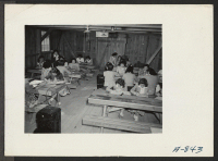 [recto] Sewing school. Evacuee students are taught here not only to design but make clothing as well. ;  Photographer: Stewart, Francis ;  Poston, Arizona.