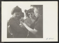 [recto] A group of girls who are residents at this center and a puppy at a football game. ;  Photographer: Parker, Tom ;  McGehee, Arkansas.
