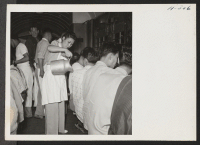 [recto] A scene in the improvised box car where between 60 and 70 transferees were fed at one time. Volunteer waitresses helped with the serving. ;  Photographer: Mace, Charles E. ; , .