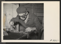 [recto] Frank K. Mizuni, former garage owner and mechanic, from Auburn, Washington, welds a radiator in the local garage, at this War Relocation Authority center. All repair work on the cars, trucks, tractors, and other vehicles is done by evacuee workers. ;  P