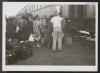 [recto] Segregants boarding on train at Case Grande. ;  Rivers, Arizona.