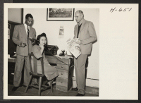 [recto] Mary Kito, Nisei from Granada, and office manager of Now magazine, is shown here with public relations man Foster Ricardo ...