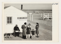 [recto] First Japanese-American family leaves Central Utah Relocation Center for California. Mrs. Saku Moriwaki, 33 (center), formerly of Berkeley, and her ...