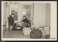 [recto] Two friends play final game while awaiting evacuation. Evacuees of Japanese descent are being housed in War Relocation Authority centers for the duration. ;  Photographer: Lange, Dorothea ;  San Francisco, California.