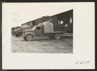 [recto] Volunteer workers loading a truck from a boxcar for transportation to the warehouse at this center. ;  Photographer: Parker, Tom ;  McGehee, Arkansas.