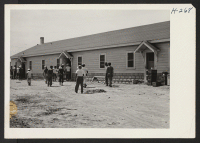 [recto] Japanese-American employees on the Hellwig Brothers farm west of St. Louis are here seen entering the specially built mess hall ...