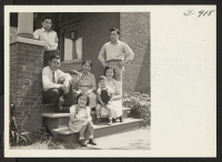 [recto] The Abe family from Colorado River, formerly of Seal Beach, California, gather on the porch of their new home to ...