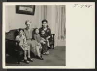 [recto] Mrs. K. Sasaki, formerly from Minidoka, poses for her picture with her three children and Miss Alice Finley, hostel director ...