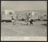 [recto] Three children, temporarily residing in the Winona Housing Project at Burbank, California, where evacuees from the centers are temporarily residing until they are able to find homes in Los Angeles or the surrounding area. ;  Photographer: Parker, Tom