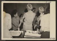 [recto] Manzanar, Calif.--Newcomers are vaccinated by evacuee nurses and doctors upon arrival at War Relocation Authority centers for evacuees of Japanese ancestry. Dr. Kazue Togasaki administering vaccine. ;  Photographer: Albers, Clem ;  Manzanar, Californi