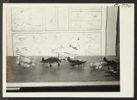 [recto] Amache High School model airplane display. ;  Photographer: McClelland, Joe ;  Amache, Colorado.