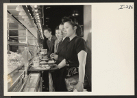 [recto] Shown with their trays at the salad counter in one of New York City's famous Automat restaurants just off Fifth Avenue are Barbara Yamamoto, Gila; Akira Kashiki, Colorado River; May Tomio, Granada; and Sam Kai, Tule Lake and Jerome. ;  Photographer: Iwa