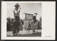 [recto] Two of the participants in the Harvest Festival Parade. Note the large crowd in the background that witnessed this parade. ;  Photographer: Stewart, Francis ;  Newell, California.