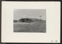 [recto] Tule Lake, Newell, Calif.--A potato warehouse used to store and cut seed potatoes by evacuee-farmer s at this War Relocation Authority center. Note that earth has been thrown over the side of the building. This protects the seed potatoes from frost and he