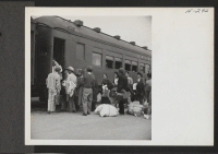 [recto] Transferees from the Topaz Center are here shown boarding the train (trip 15) for their new home at Tule Lake. ;  Photographer: Mace, Charles E. ;  Topaz, Utah.
