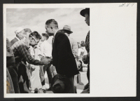 [recto] OUTGOING--Farewell shake at high school grounds. ;  Photographer: Aoyama, Bud ;  Heart Mountain, Wyoming.