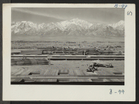 [recto] Construction begins at Manzanar, now a War Relocation Authority Center for evacuees of Japanese ancestry, in Owens Valley, flanked by the High Sierras and Mt. Whitney, loftiest peak in the United States. ;  Photographer: Albers, Clem ;  Manzanar, Cali