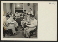[recto] Closing of the Jerome Center, Denson, Arkansas. Assistant Project Director W. O. Melton meets with the block managers to make selections for train captains, monitors, etc., prior to the movements of residents to other centers. ;  Photographer: Iwasaki,
