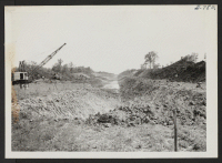 [recto] The main drainage ditch, facing South, when it had been carved to a point 500 ft. South of where it will cross State Highway 14. ;  Photographer: Lynn, Charles R. ;  Dermott, Arkansas.