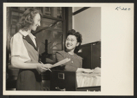 [recto] Mrs. Helen Matsumoto is shown in the file room of the FPHA. Mrs. Matsumoto is formerly of Poston and is now residing in San Francisco. Her husband, Staff Sergeant George Matsumoto, is stationed in Italy. ;  Photographer: Iwasaki, Hikaru ;  San Francis